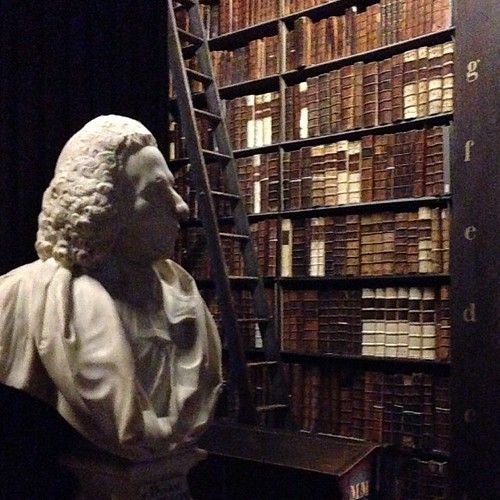 Shelves of old books in a grand library